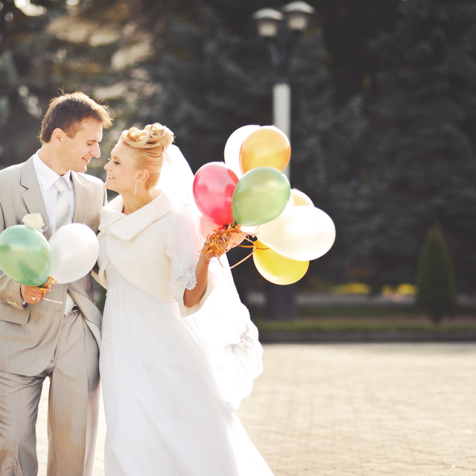 Young newlywed couple with balloons