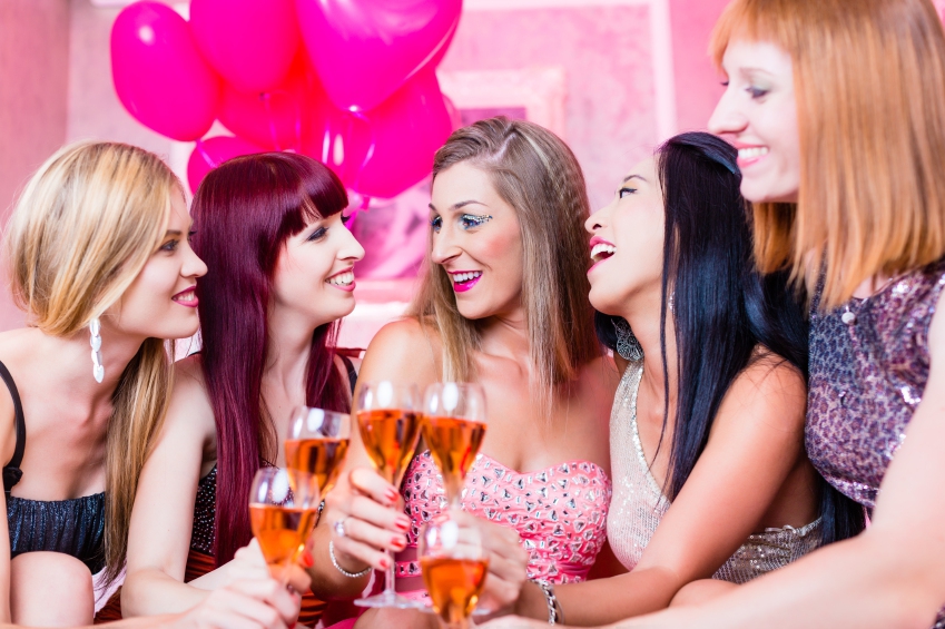 Women partying with champagne in night club