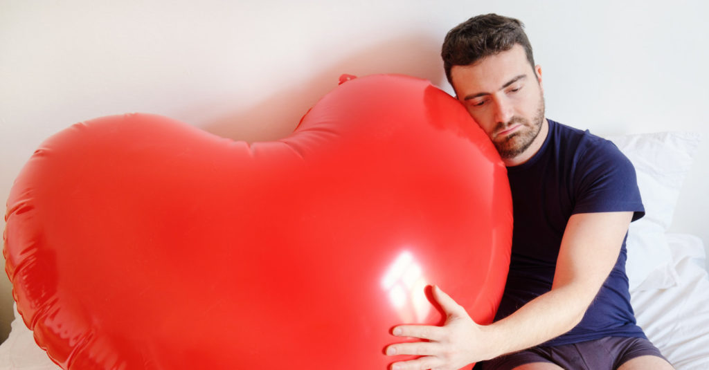 Man Hugging a Heart-Shaped Balloon