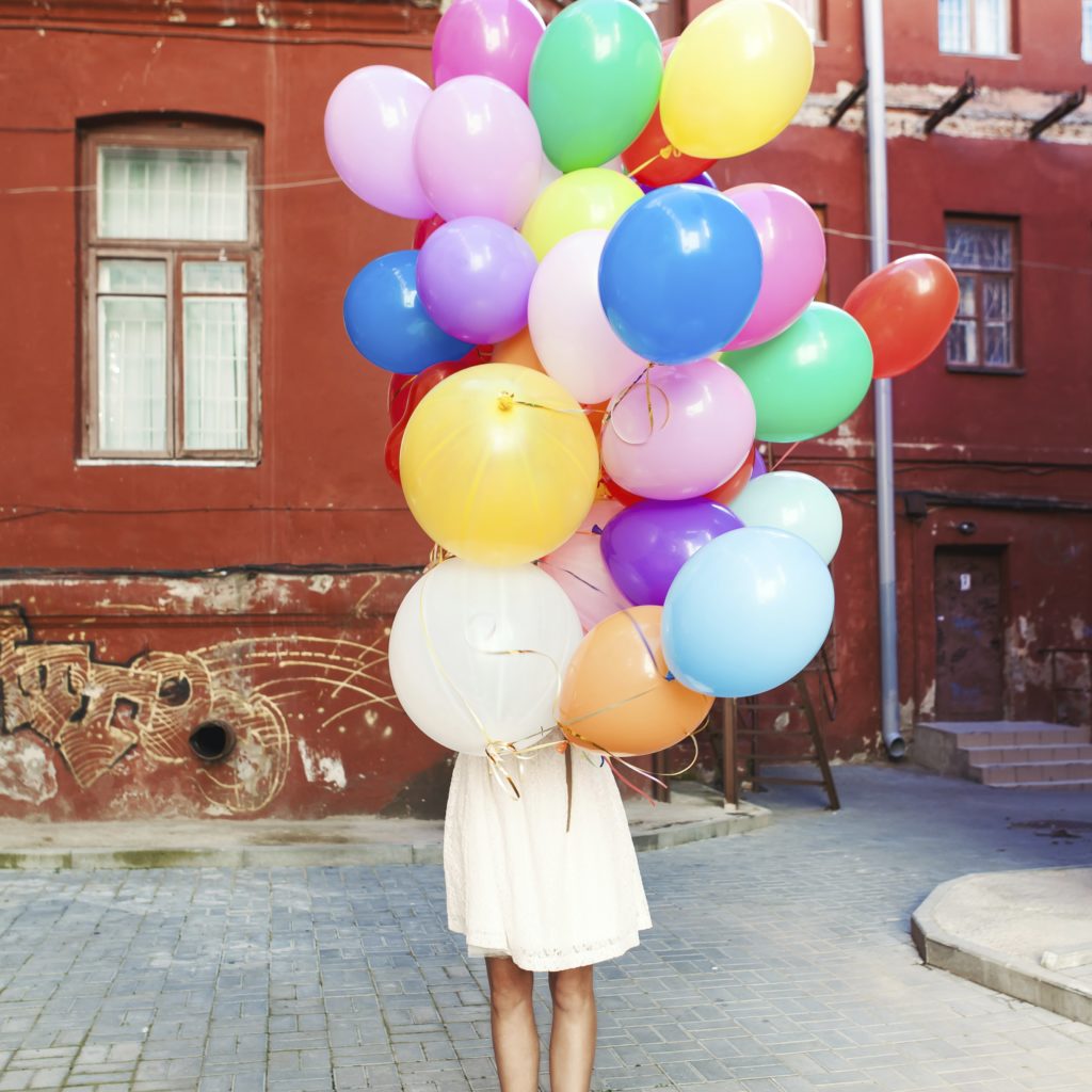 A Woman Holding Balloons
